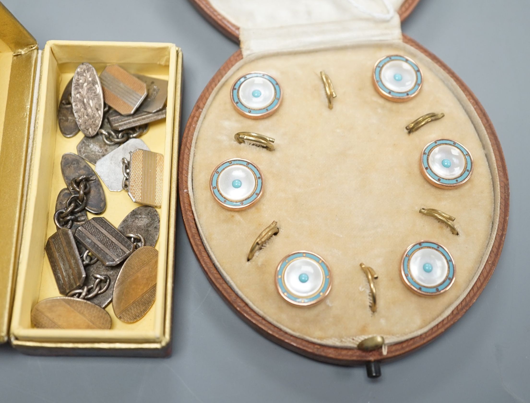 A cased early 20th century six piece gilt metal, mother of pearl and enamel dress stud set and four pairs of silver or white metal cufflinks.